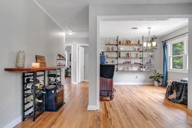 1818 Homewood Rd, Tallahassee, FL 32303 - interior space featuring light wood-type flooring, attic access, baseboards, and a chandelier