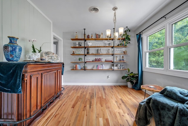 1818 Homewood Rd, Tallahassee, FL 32303 - sitting room featuring light wood-style floors, a chandelier, and baseboards