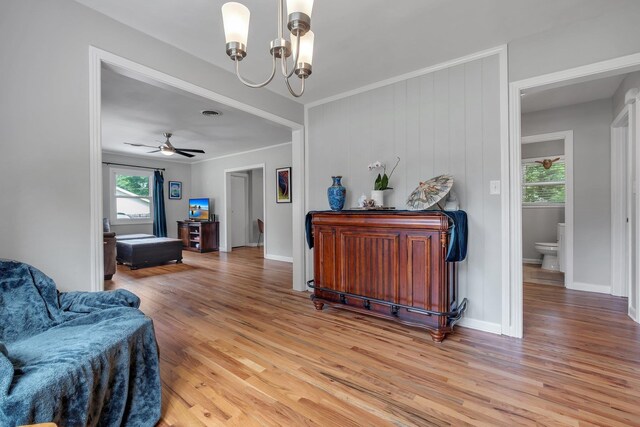 1818 Homewood Rd, Tallahassee, FL 32303 - hallway featuring a chandelier, healthy amount of natural light, light wood finished floors, and crown molding