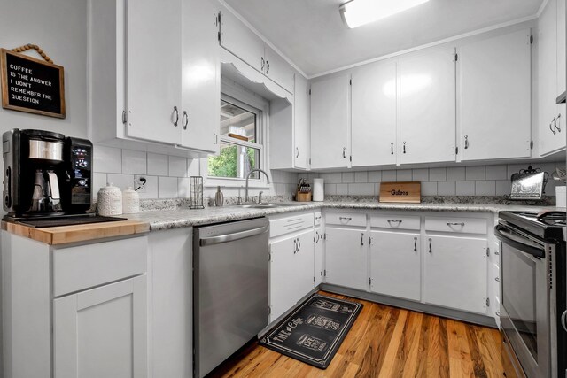 1818 Homewood Rd, Tallahassee, FL 32303 - kitchen with appliances with stainless steel finishes, a sink, light countertops, white cabinetry, and light wood finished floors