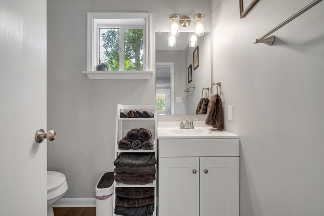 1818 Homewood Rd, Tallahassee, FL 32303 - half bathroom featuring vanity, plenty of natural light, toilet, and baseboards