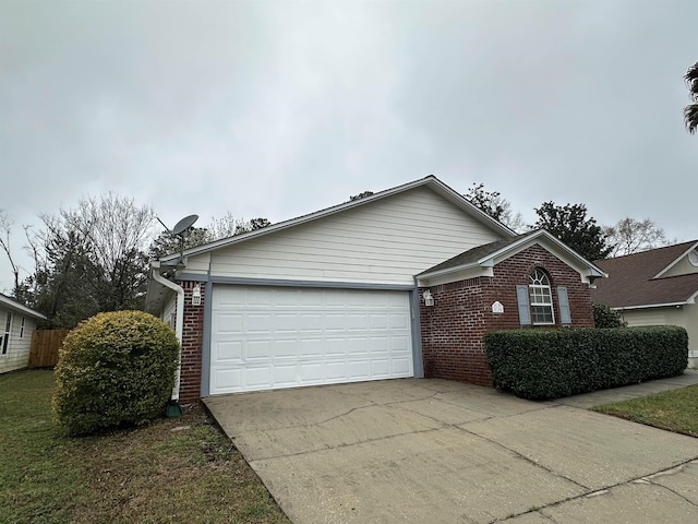 single story home with brick siding, an attached garage, concrete driveway, and fence