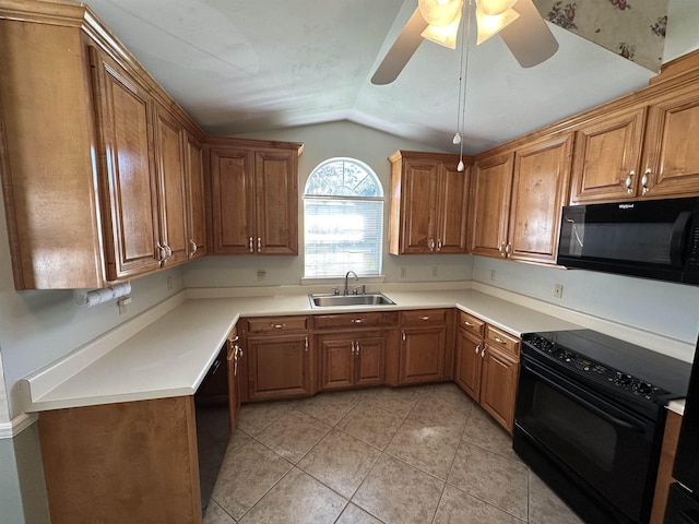 kitchen with brown cabinetry, black appliances, and a sink