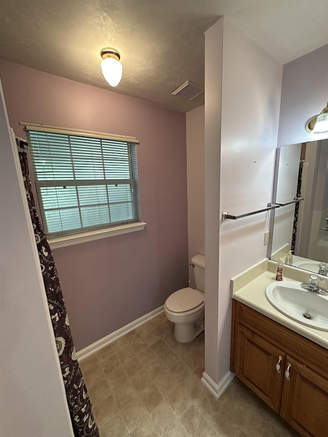 full bathroom with visible vents, baseboards, toilet, and vanity