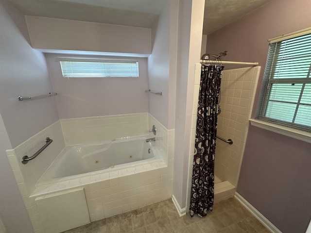 full bathroom featuring plenty of natural light, a whirlpool tub, and a shower stall