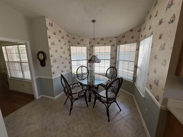 dining space featuring plenty of natural light, wallpapered walls, and baseboards