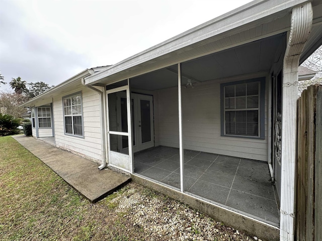 back of property with a patio and a sunroom