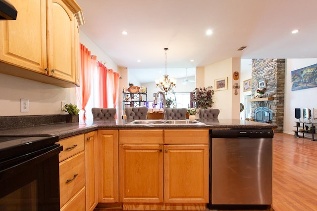 kitchen featuring stainless steel dishwasher, light hardwood / wood-style floors, plenty of natural light, and sink