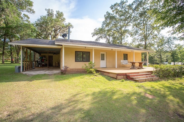 back of property with a patio area and a lawn