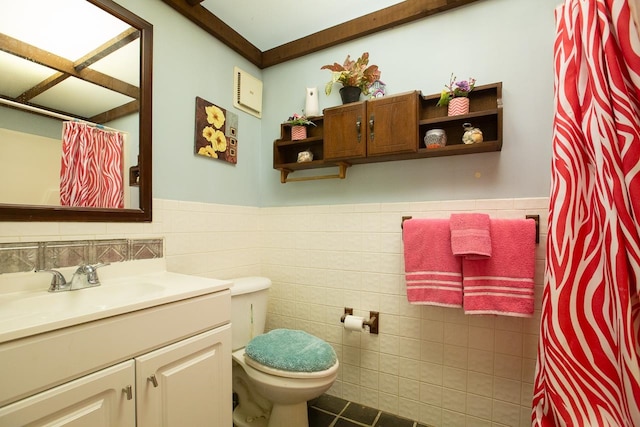 bathroom featuring vanity, toilet, and tile walls