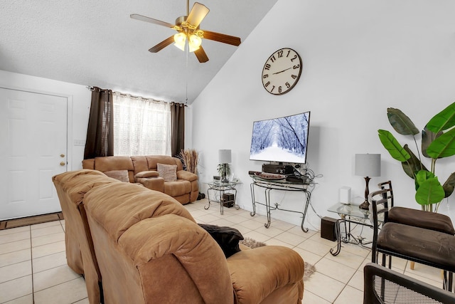 living area featuring a textured ceiling, high vaulted ceiling, light tile patterned flooring, and a ceiling fan