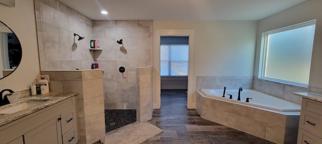 bathroom featuring vanity, separate shower and tub, and hardwood / wood-style floors