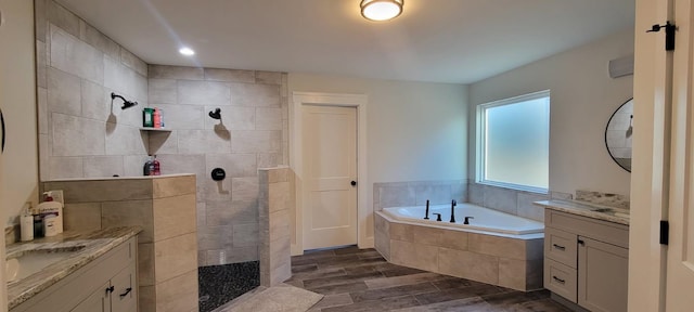 bathroom featuring vanity and shower with separate bathtub