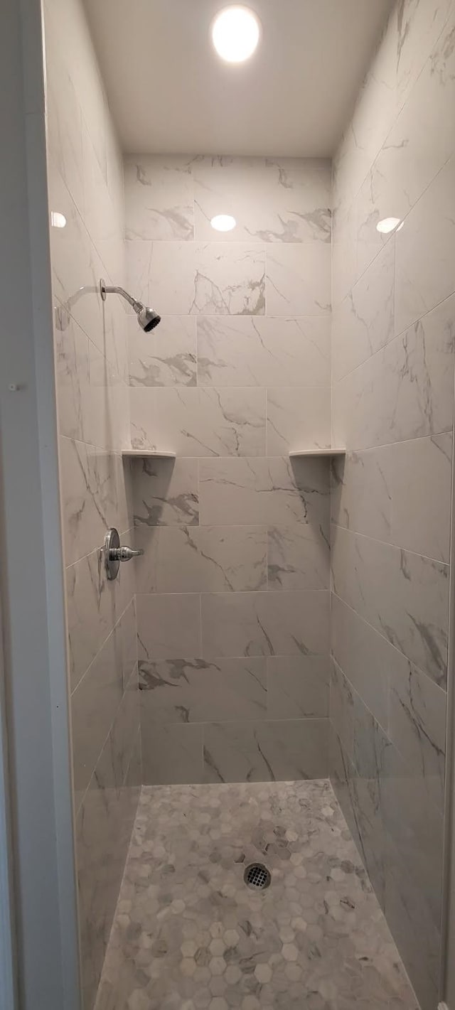 bathroom with tiled shower