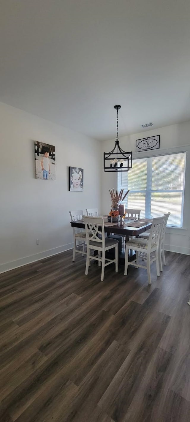 dining area with dark hardwood / wood-style flooring