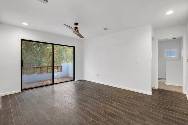 empty room featuring ceiling fan and dark wood-type flooring