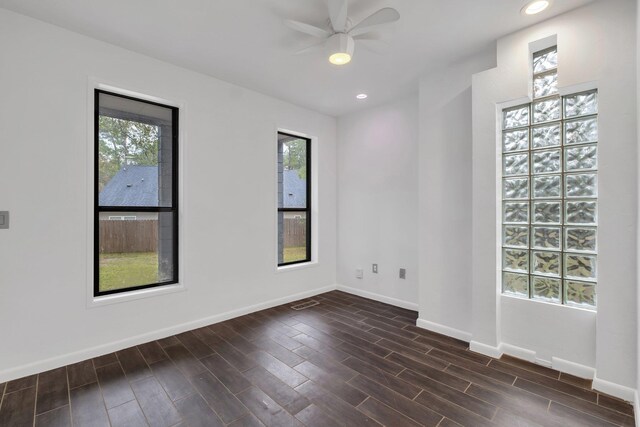 unfurnished room featuring ceiling fan and dark hardwood / wood-style floors