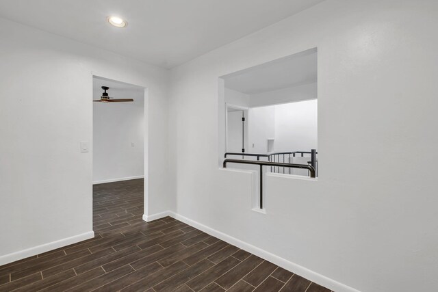 empty room featuring ceiling fan and dark hardwood / wood-style floors