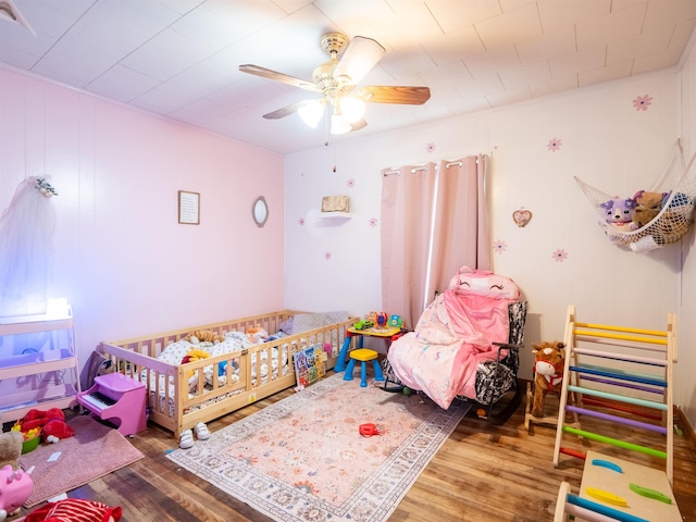 bedroom featuring hardwood / wood-style floors and ceiling fan