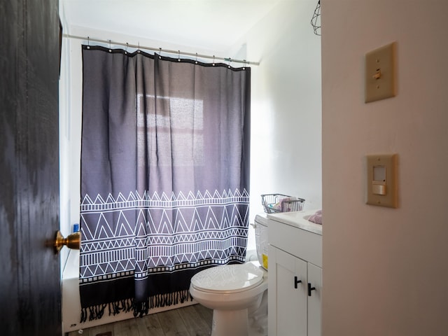 bathroom with vanity, toilet, curtained shower, and wood-type flooring