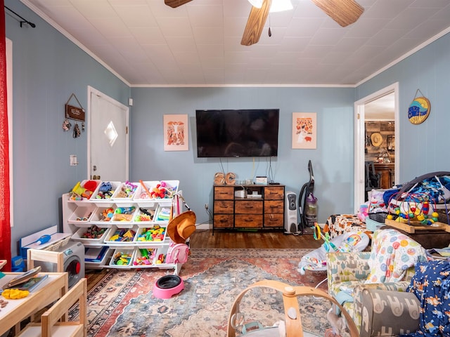 bedroom featuring dark wood-type flooring, ornamental molding, and ceiling fan