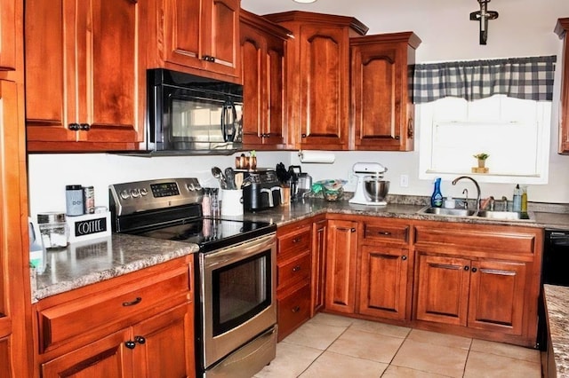 kitchen featuring light tile patterned floors, dark stone counters, sink, and electric range