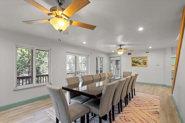 dining space featuring ceiling fan, french doors, and light hardwood / wood-style floors