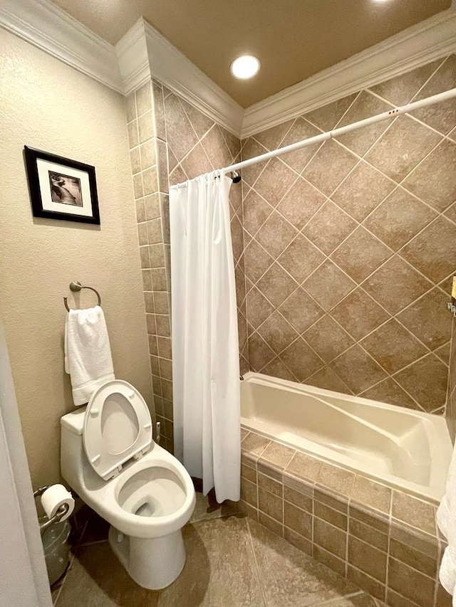 bathroom with ornamental molding, shower / bath combination with curtain, and toilet