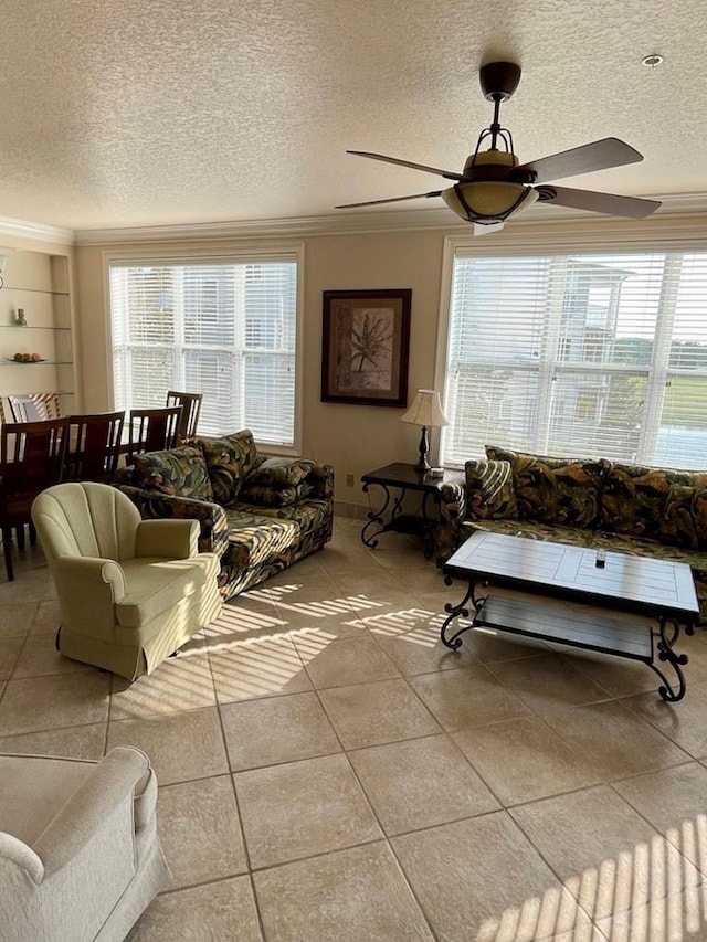 living room featuring plenty of natural light, a textured ceiling, ceiling fan, and light tile patterned floors