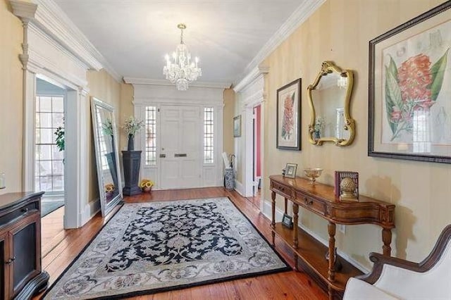 entryway featuring a notable chandelier, crown molding, plenty of natural light, and hardwood / wood-style floors