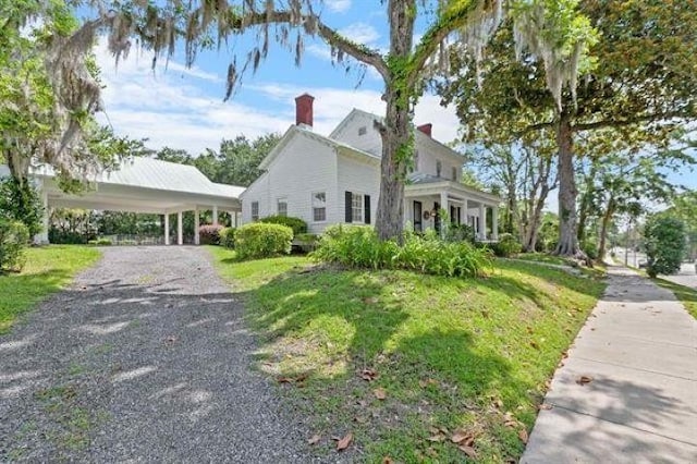 view of front of property with a carport and a front yard