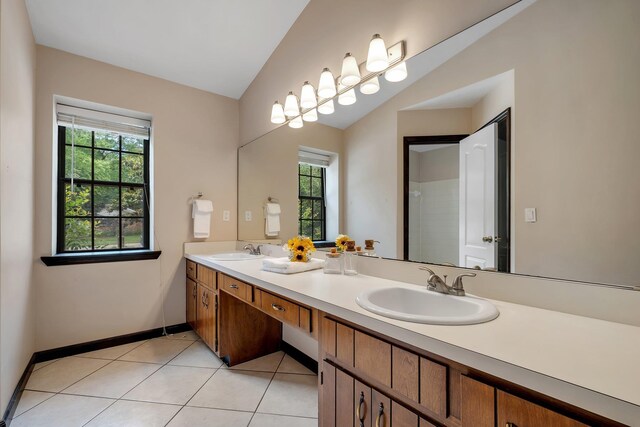 2825 Ohara Dr, Tallahassee, FL 32309 - bathroom with double vanity, tile patterned flooring, and baseboards