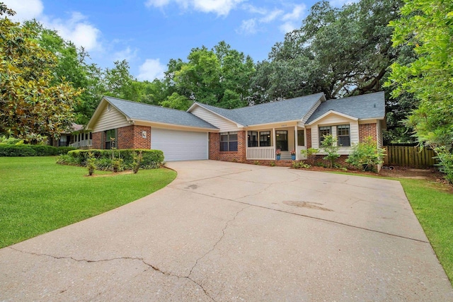 2825 Ohara Dr, Tallahassee, FL 32309 - ranch-style house featuring brick siding, a porch, driveway, a garage, and roof with shingles
