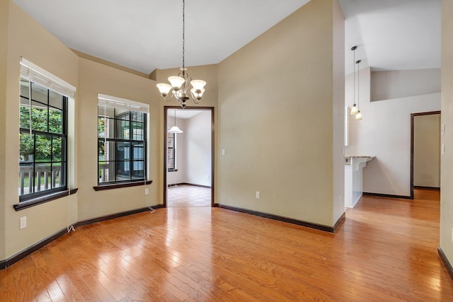 2825 Ohara Dr, Tallahassee, FL 32309 - empty room with light wood-style floors, a chandelier, and baseboards