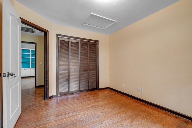 2825 Ohara Dr, Tallahassee, FL 32309 - unfurnished bedroom with attic access, light wood-type flooring, baseboards, and a closet