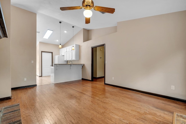 2825 Ohara Dr, Tallahassee, FL 32309 - unfurnished living room with ceiling fan, lofted ceiling, light wood finished floors, and baseboards