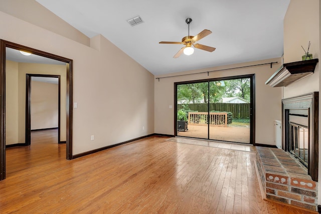2825 Ohara Dr, Tallahassee, FL 32309 - unfurnished living room with lofted ceiling, light wood-style flooring, ceiling fan, a fireplace, and baseboards