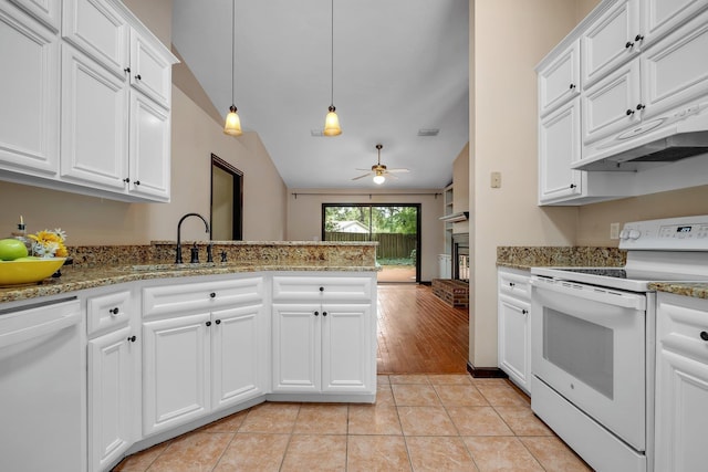 2825 Ohara Dr, Tallahassee, FL 32309 - kitchen with white appliances, ceiling fan, a fireplace, lofted ceiling, and a peninsula