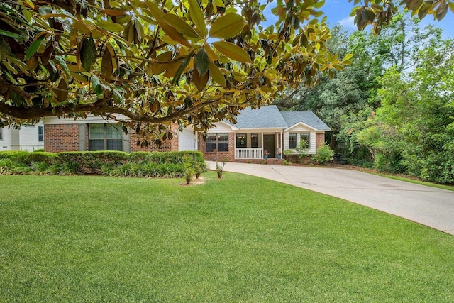 2825 Ohara Dr, Tallahassee, FL 32309 - view of front facade featuring brick siding, a front lawn, and concrete driveway