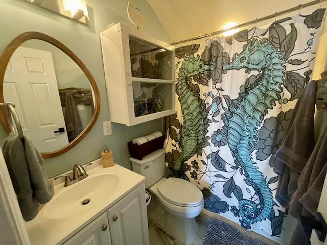 bathroom with toilet, lofted ceiling, and vanity