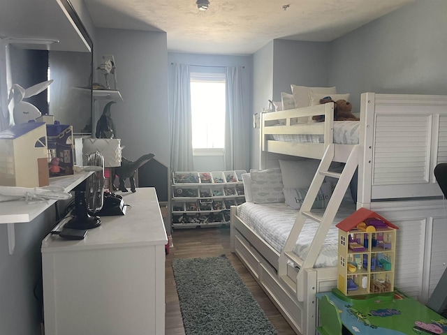 bedroom with dark wood-type flooring