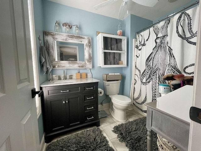 bathroom with marble finish floor, toilet, a ceiling fan, vanity, and baseboards