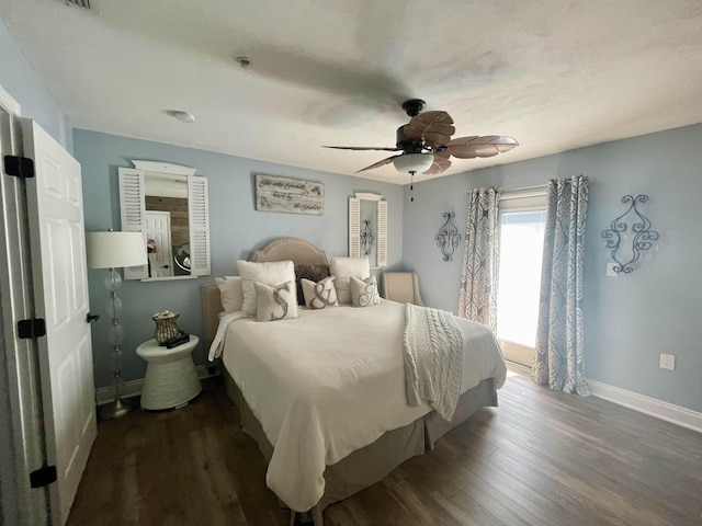 bedroom featuring a ceiling fan, baseboards, and dark wood-style flooring