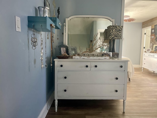 interior space with wood finished floors and baseboards