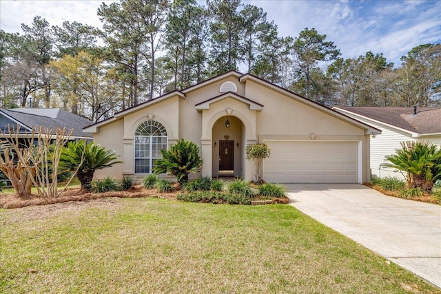 view of front of house with a garage, driveway, a front lawn, and stucco siding