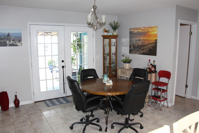 tiled dining area with french doors and a chandelier