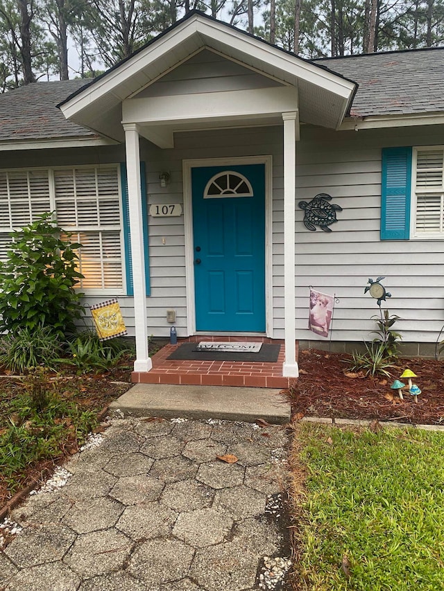 view of exterior entry with covered porch