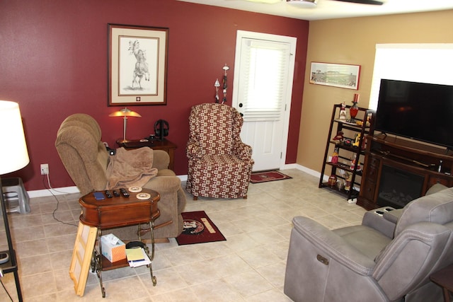 tiled living room featuring ceiling fan