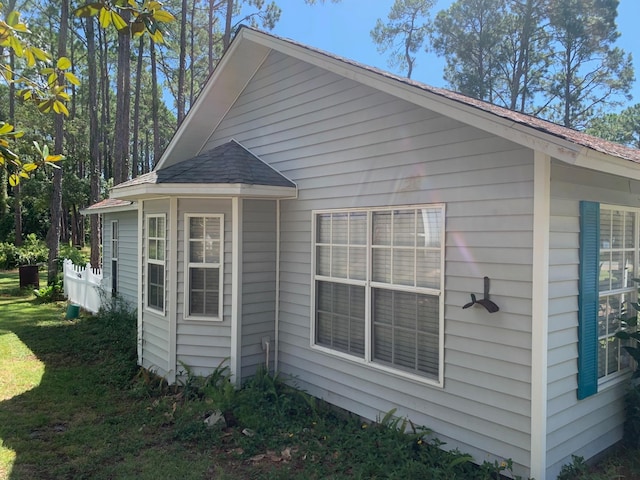 view of side of home featuring a yard