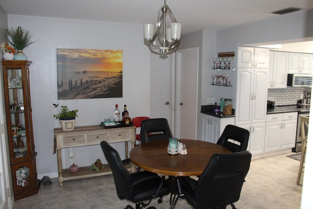 dining room featuring a chandelier and light tile patterned floors